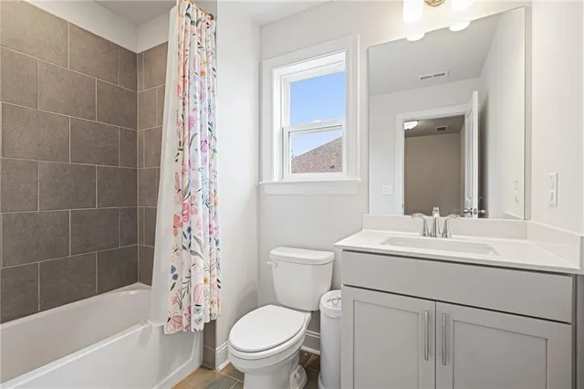 a bathroom with a sink toilet vanity and tub