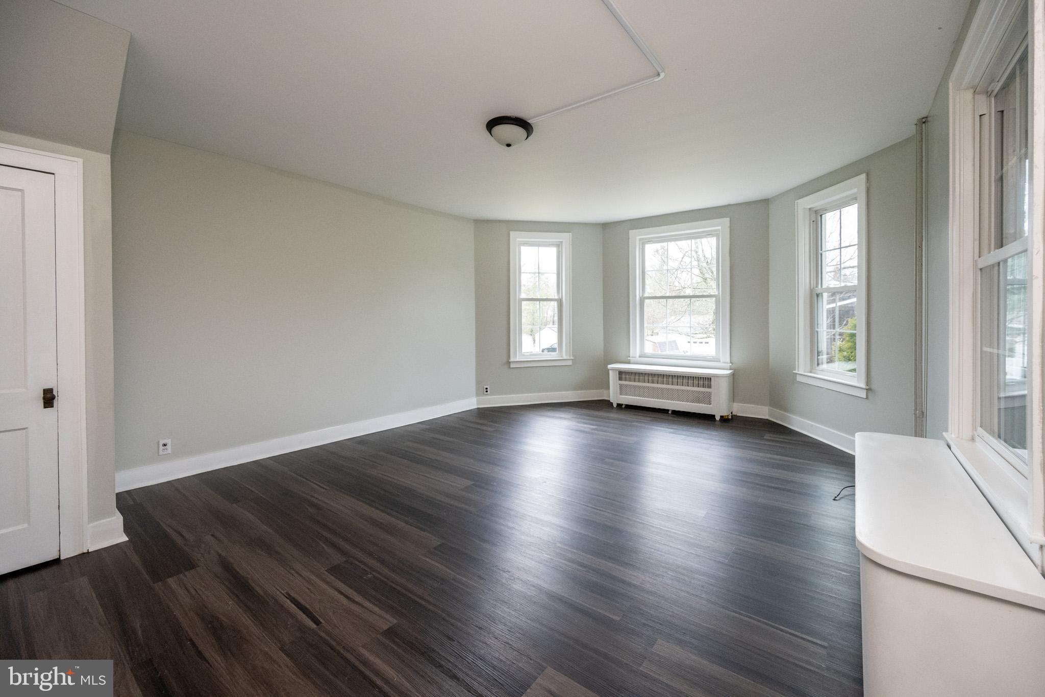 449 South 3rd Street Oakland, MD 21550 - Photo 16 of 64 an empty room with wooden floor and windows