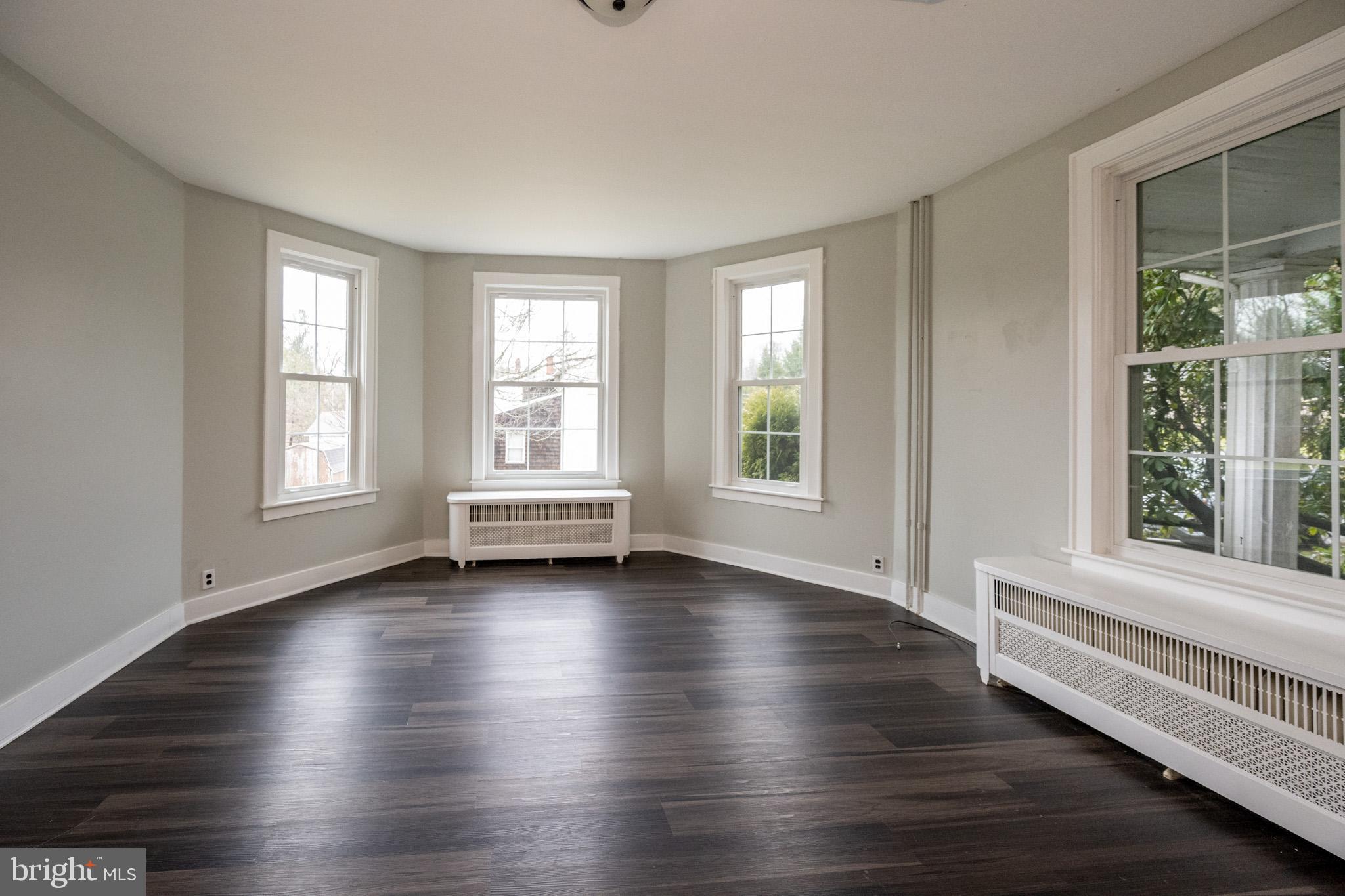 449 South 3rd Street Oakland, MD 21550 - Photo 17 of 64 an empty room with wooden floor and windows