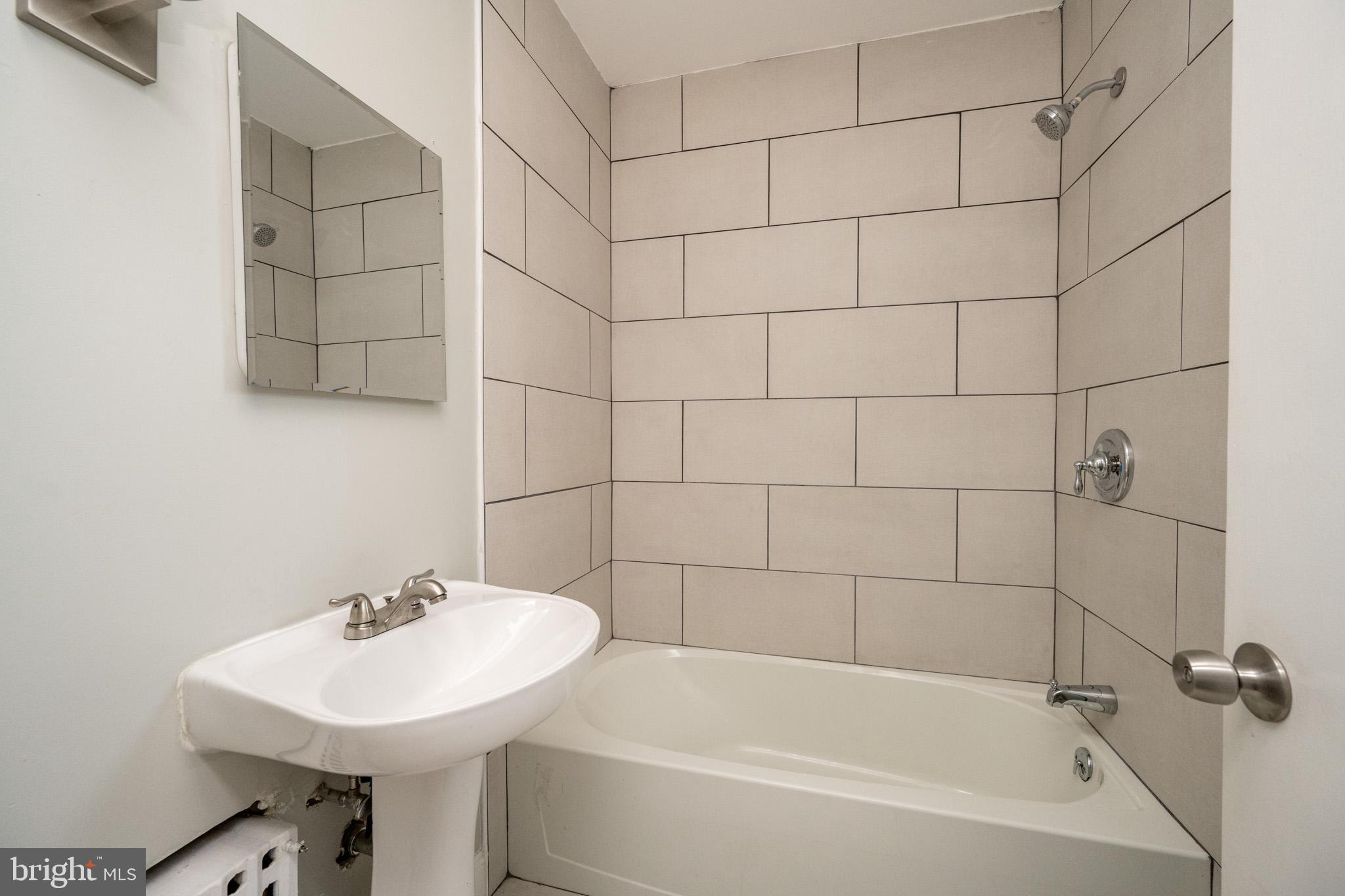 449 South 3rd Street Oakland, MD 21550 - Photo 23 of 64 a white bath tub sitting next to a white sink