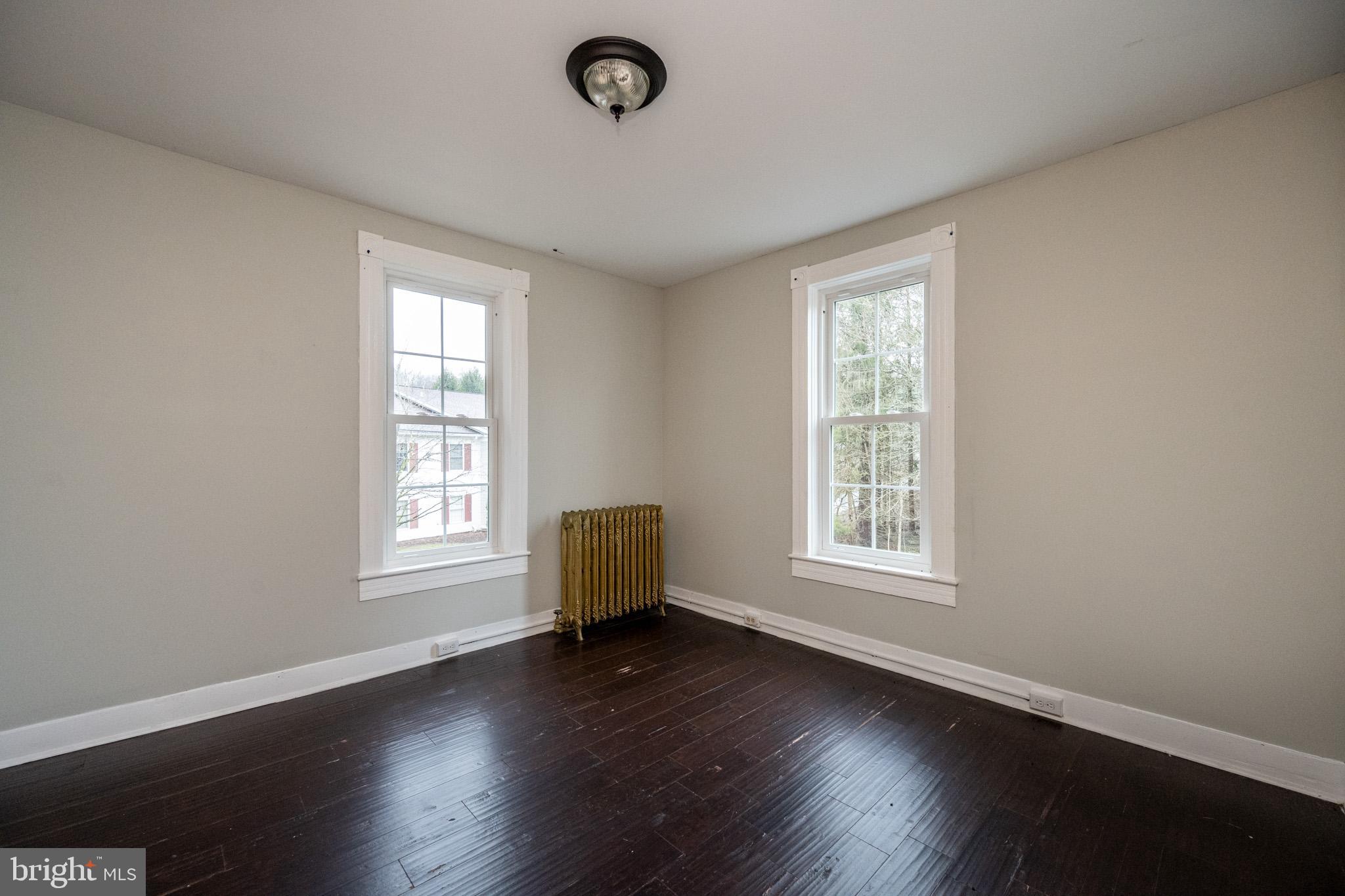 449 South 3rd Street Oakland, MD 21550 - Photo 27 of 64 an empty room with wooden floor and windows