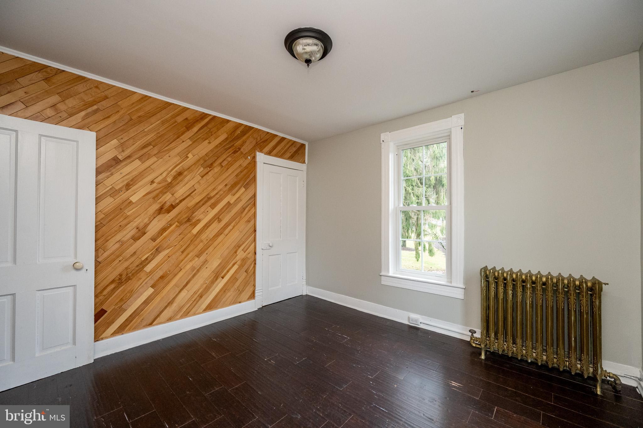 449 South 3rd Street Oakland, MD 21550 - Photo 28 of 64 an empty room with wooden floor and windows