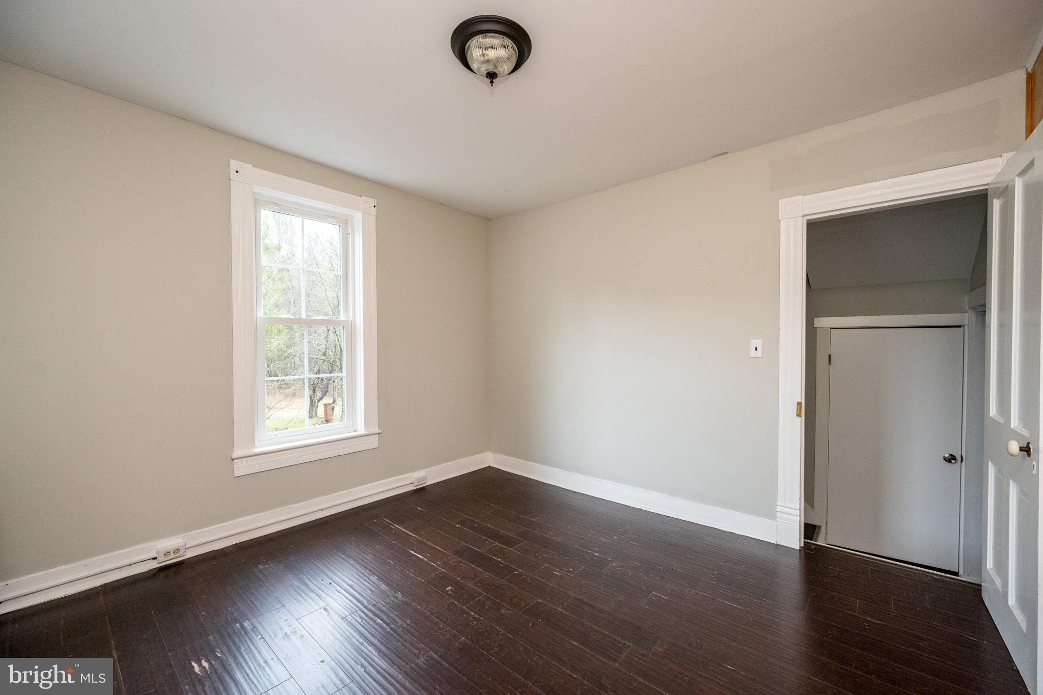 449 South 3rd Street Oakland, MD 21550 - Photo 30 of 64 an empty room with wooden floor and windows