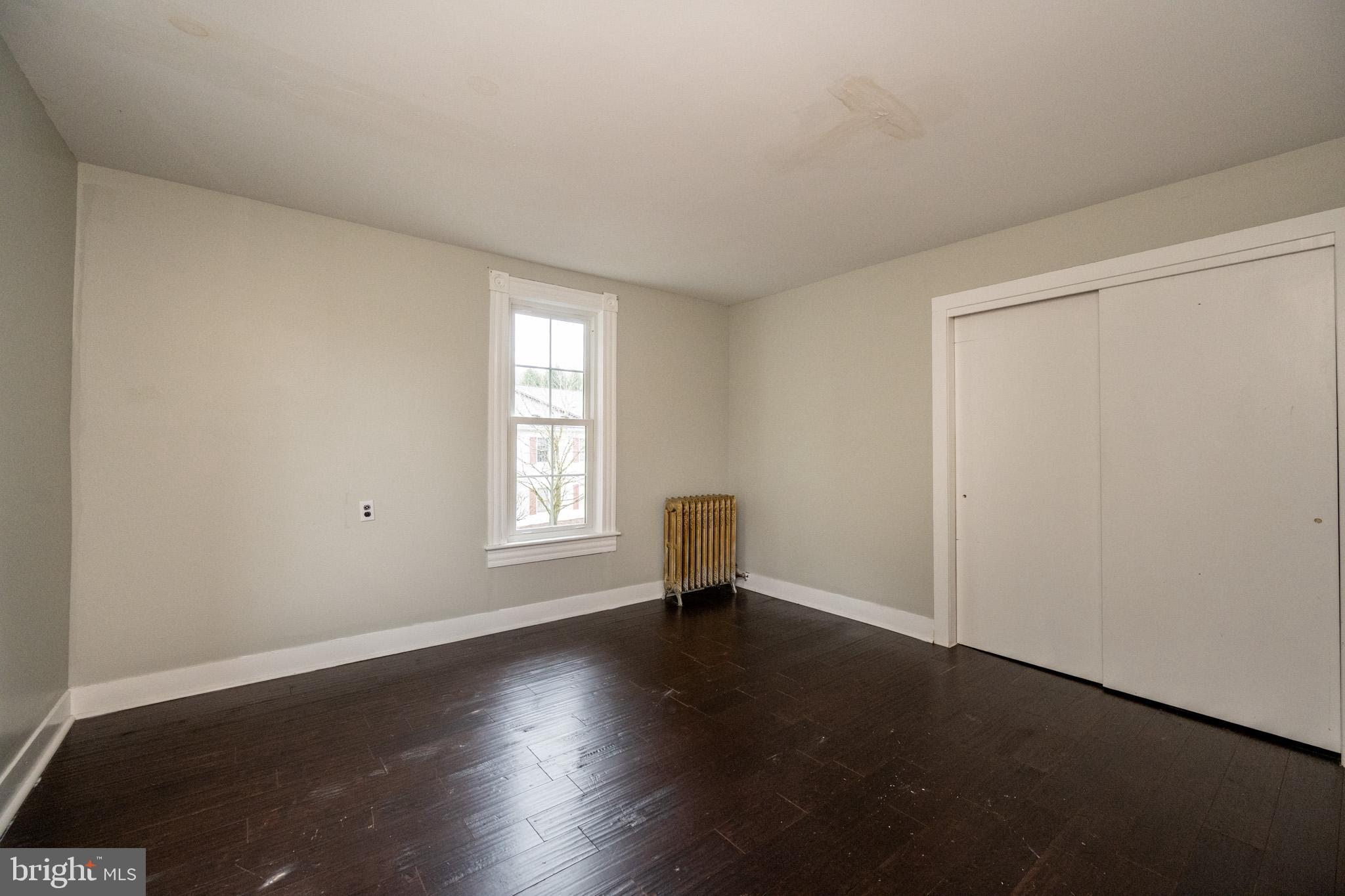 449 South 3rd Street Oakland, MD 21550 - Photo 37 of 64 an empty room with wooden floor and windows