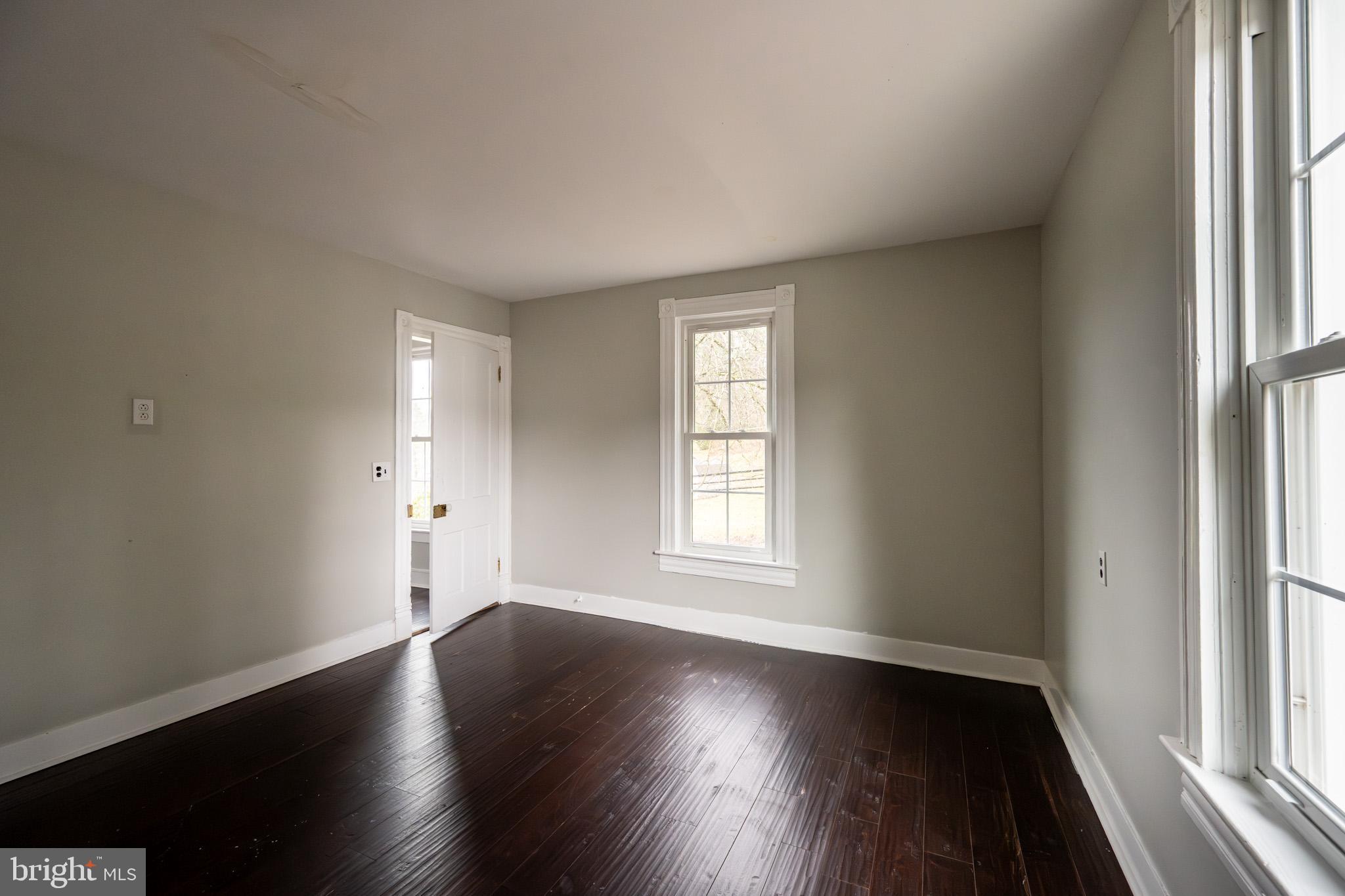 449 South 3rd Street Oakland, MD 21550 - Photo 39 of 64 an empty room with wooden floor and windows