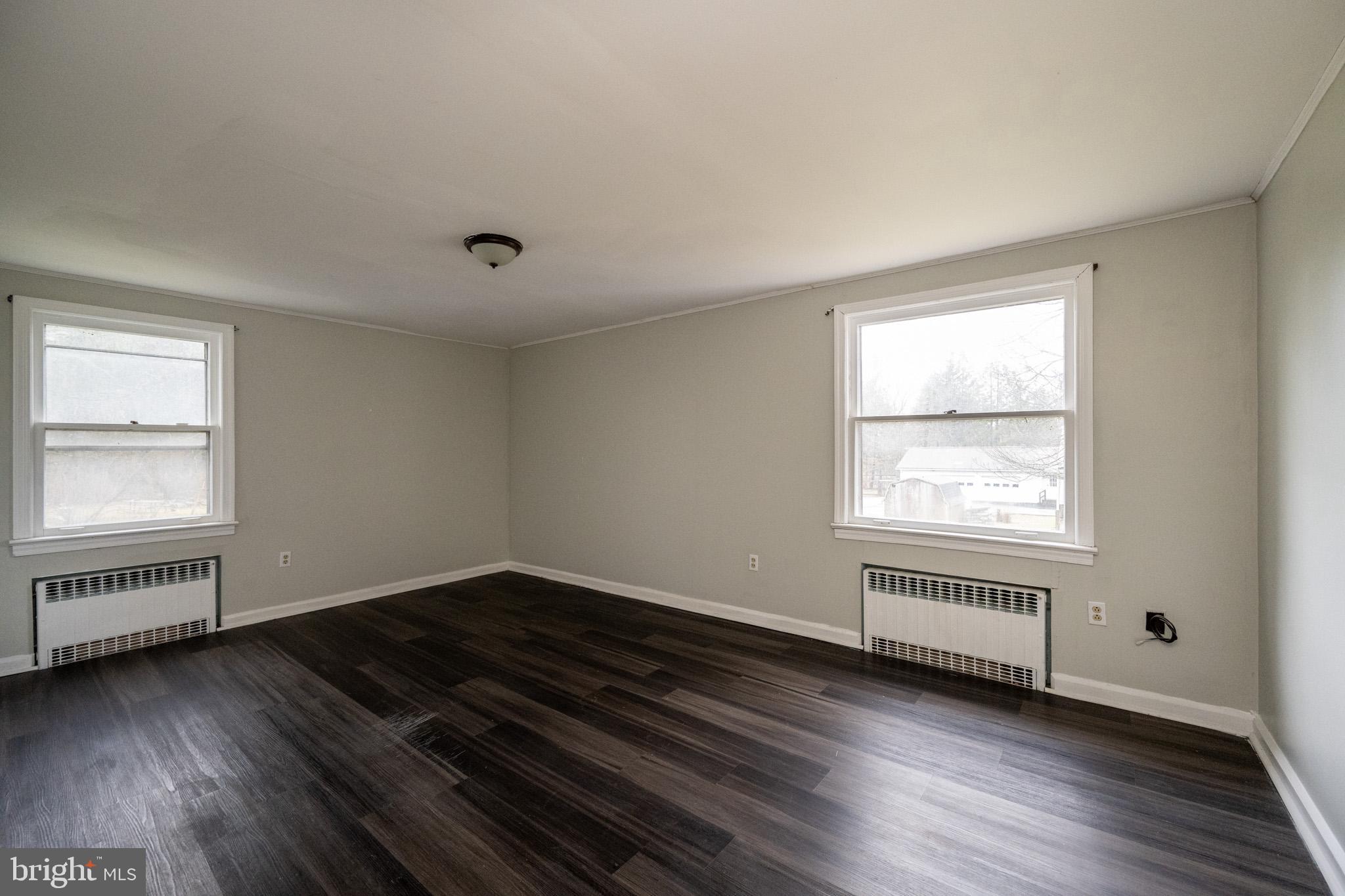 449 South 3rd Street Oakland, MD 21550 - Photo 41 of 64 an empty room with wooden floor and windows