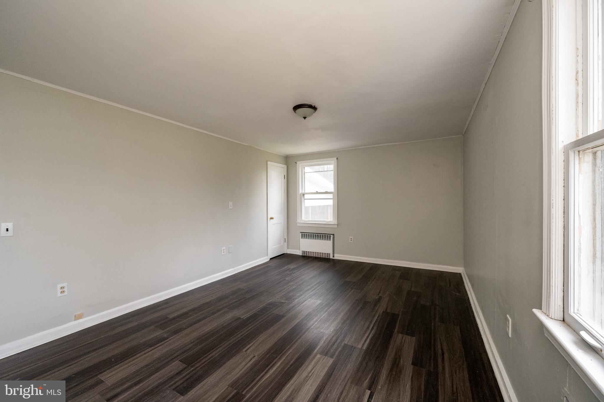 449 South 3rd Street Oakland, MD 21550 - Photo 42 of 64 a view of an empty room with wooden floor and a window