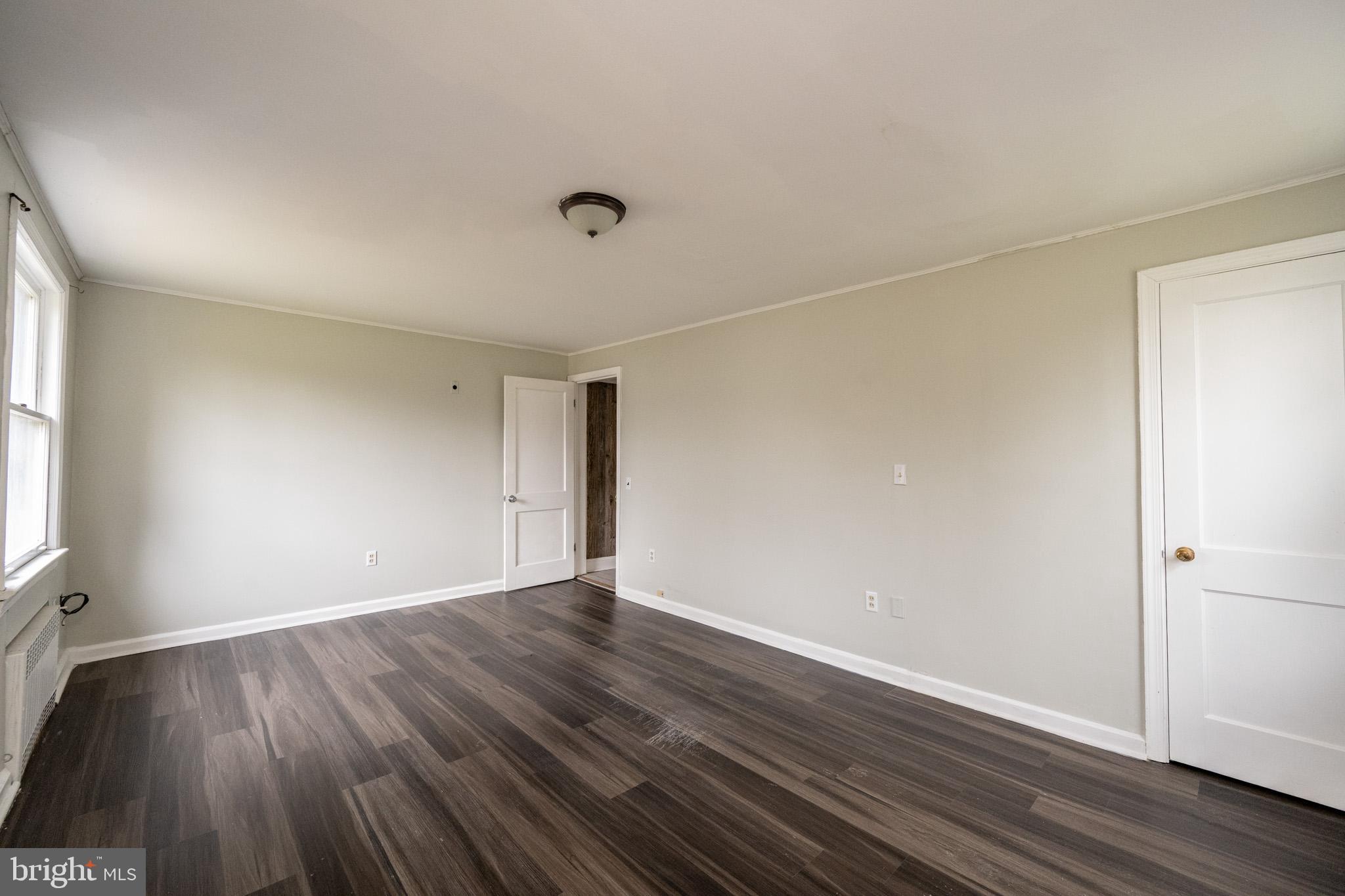 449 South 3rd Street Oakland, MD 21550 - Photo 43 of 64 an empty room with wooden floor and windows
