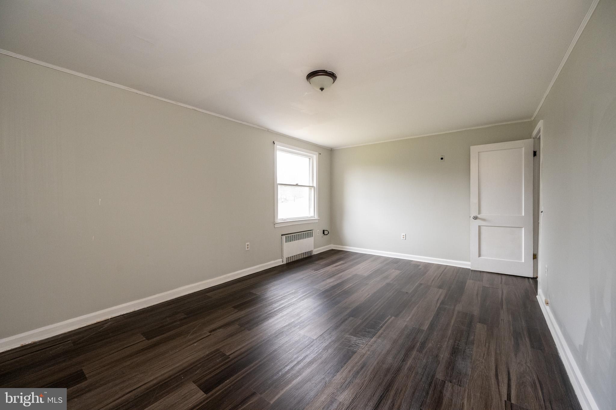 449 South 3rd Street Oakland, MD 21550 - Photo 44 of 64 a view of an empty room with wooden floor and window