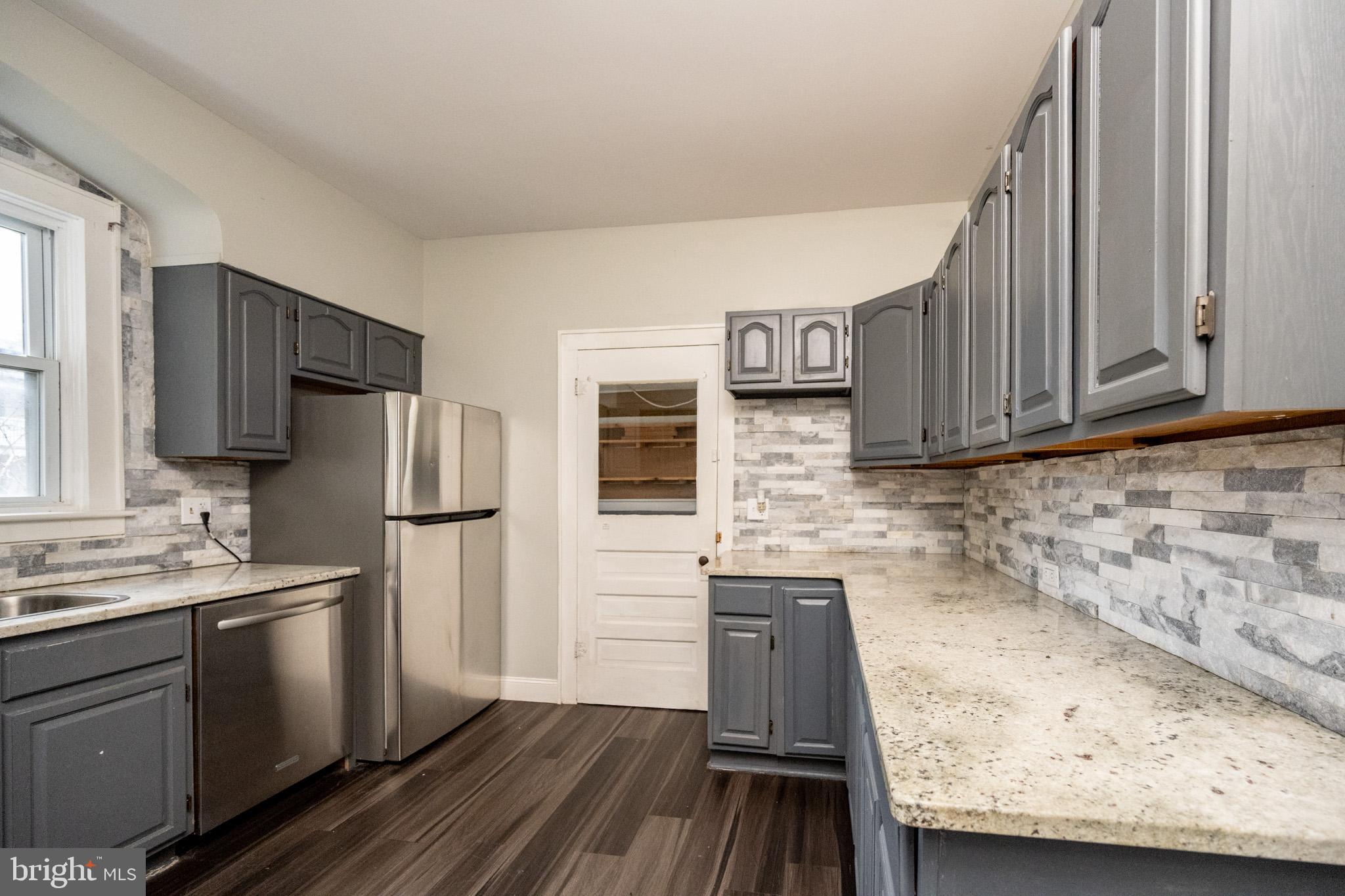 449 South 3rd Street Oakland, MD 21550 - Photo 8 of 64 a kitchen with stainless steel appliances granite countertop a refrigerator stove and sink