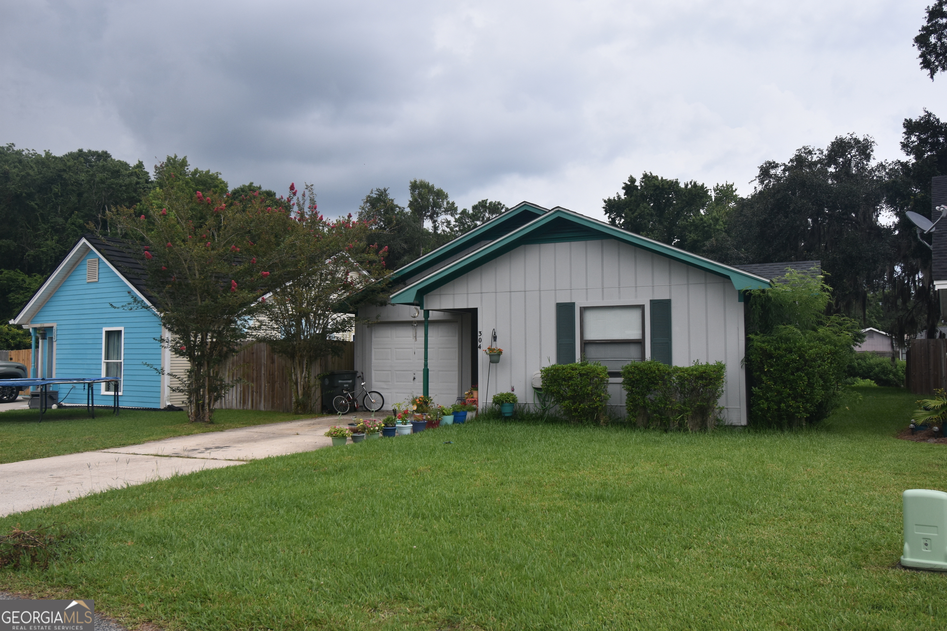 a view of a house with a yard and a garden
