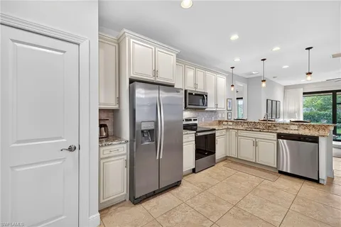 a large kitchen with cabinets and stainless steel appliances