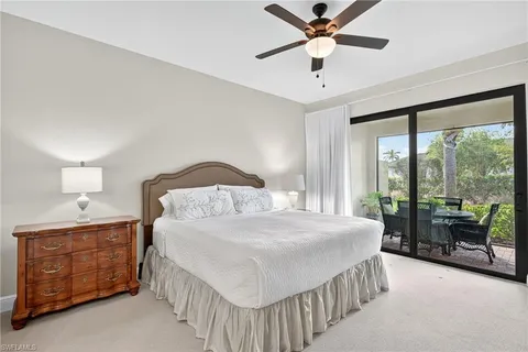 a bedroom with a bed and a ceiling fan