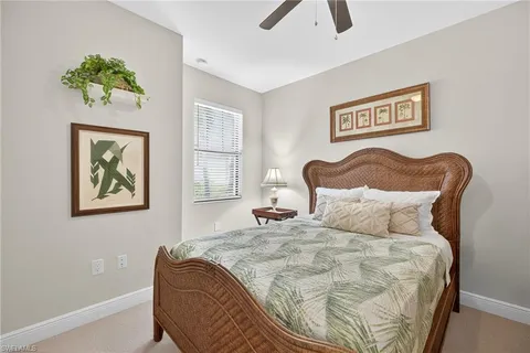 a bedroom with a bed and painting on the wall