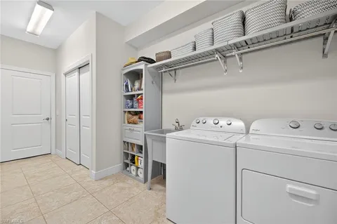 a view of storage and utility room with washer and dryer