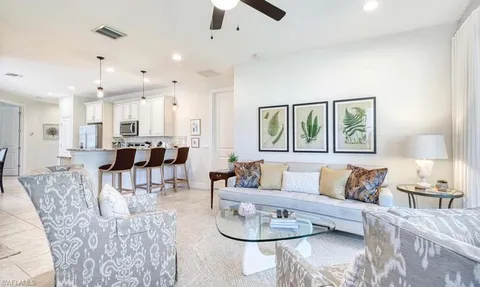 a living room with furniture and a dining table
