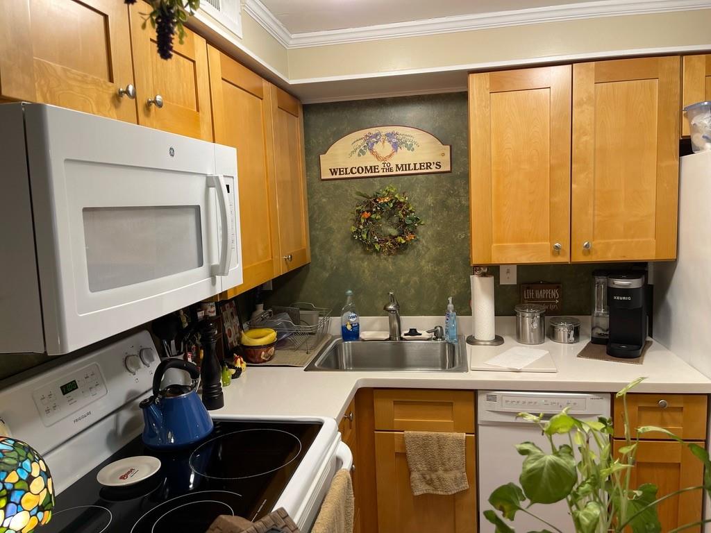 507 Hunters Path Road, Unit 12B Bridgeville, PA 15017 - Photo 14 of 25 a kitchen with a stove a sink and a microwave