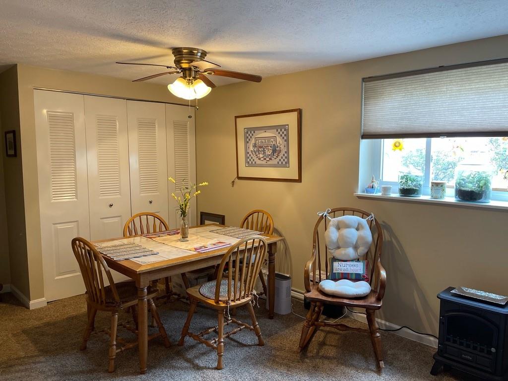 507 Hunters Path Road, Unit 12B Bridgeville, PA 15017 - Photo 16 of 25 a view of a dining room with furniture and chandelier