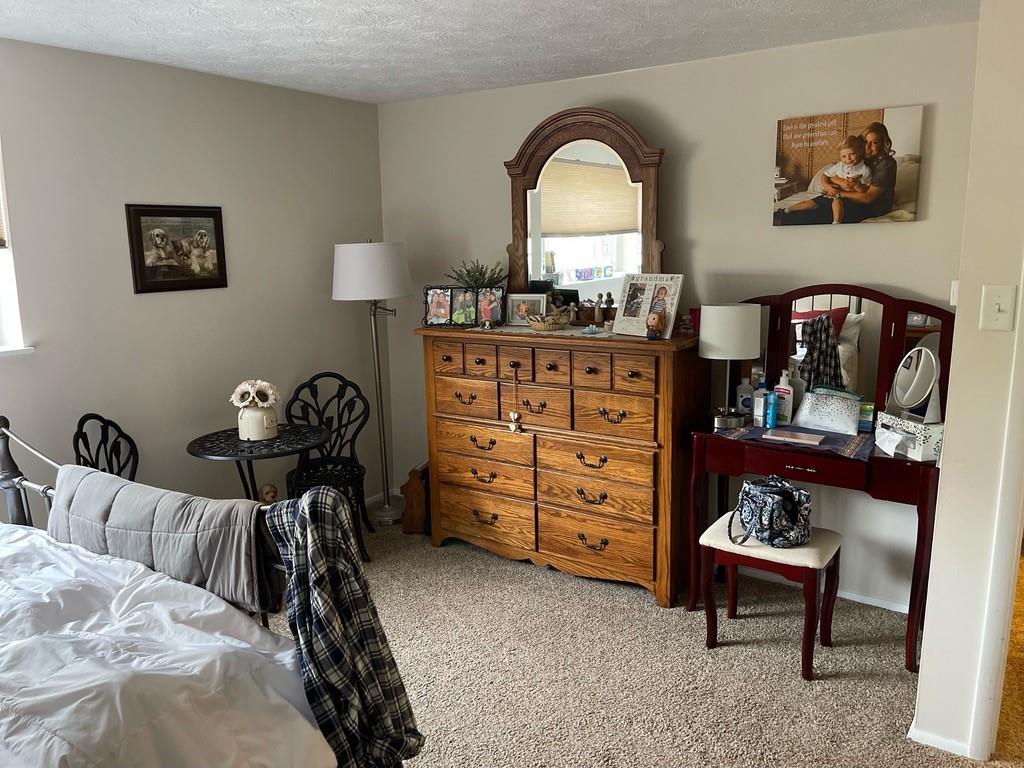 507 Hunters Path Road, Unit 12B Bridgeville, PA 15017 - Photo 19 of 25 a bed room with a bed and a dresser