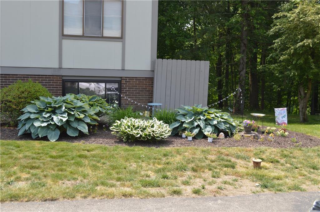 507 Hunters Path Road, Unit 12B Bridgeville, PA 15017 - Photo 25 of 25 a view of a chair and table in the garden