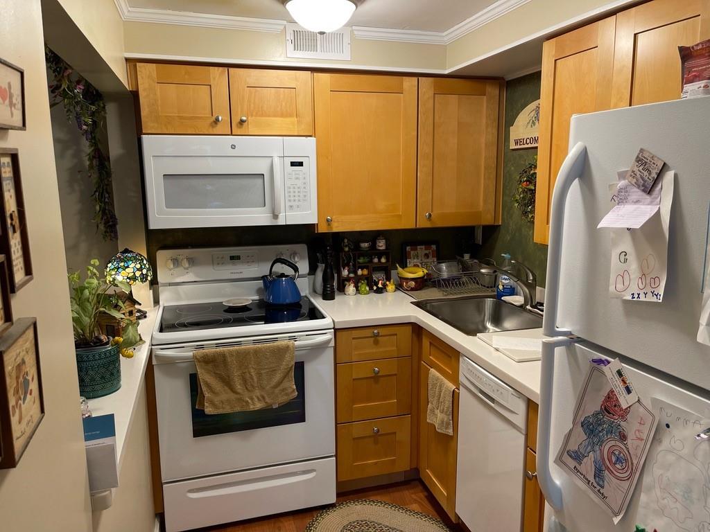 507 Hunters Path Road, Unit 12B Bridgeville, PA 15017 - Photo 7 of 25 a kitchen with stainless steel appliances a stove a sink and a refrigerator