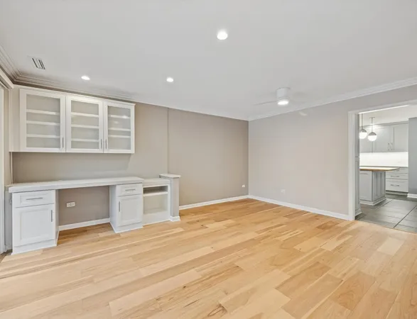 a view of empty room with wooden floor and window