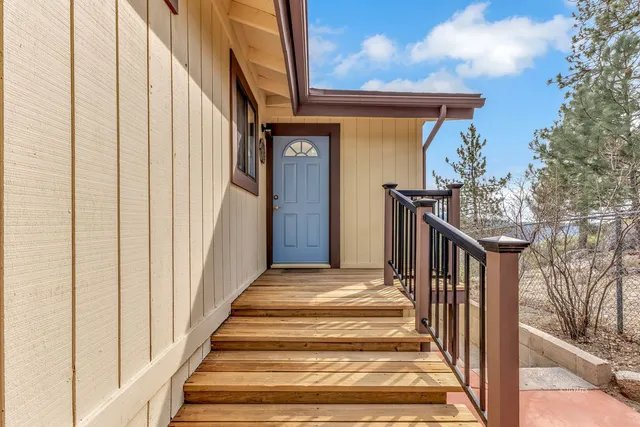 a living room with furniture large windows and a fireplace