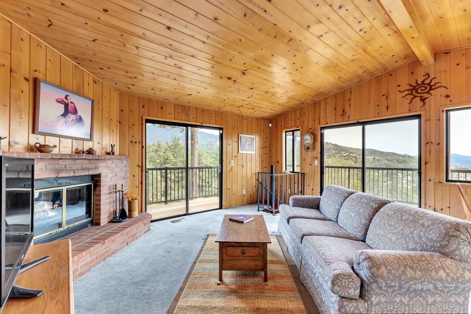 53440 West Ridge Road Idyllwild, CA 92549 - Photo 21 of 66 a living room with furniture large windows and a fireplace