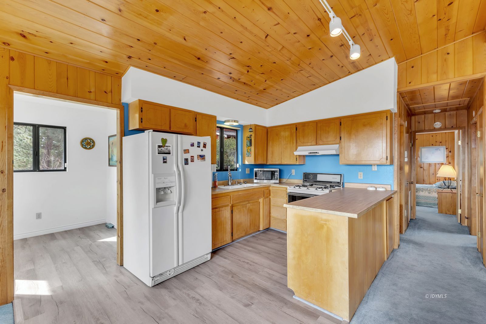 53440 West Ridge Road Idyllwild, CA 92549 - Photo 25 of 66 a kitchen with stainless steel appliances a stove a refrigerator a sink dishwasher and wooden cabinets with wooden floor