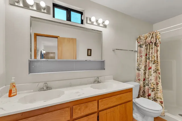 a bedroom with furniture and a large window