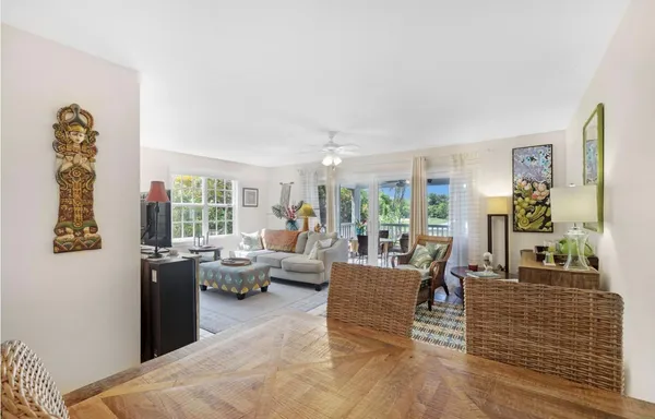 a living room with furniture windows and wooden floor