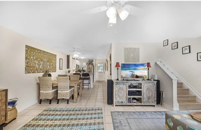 a living room with furniture a rug and a chandelier