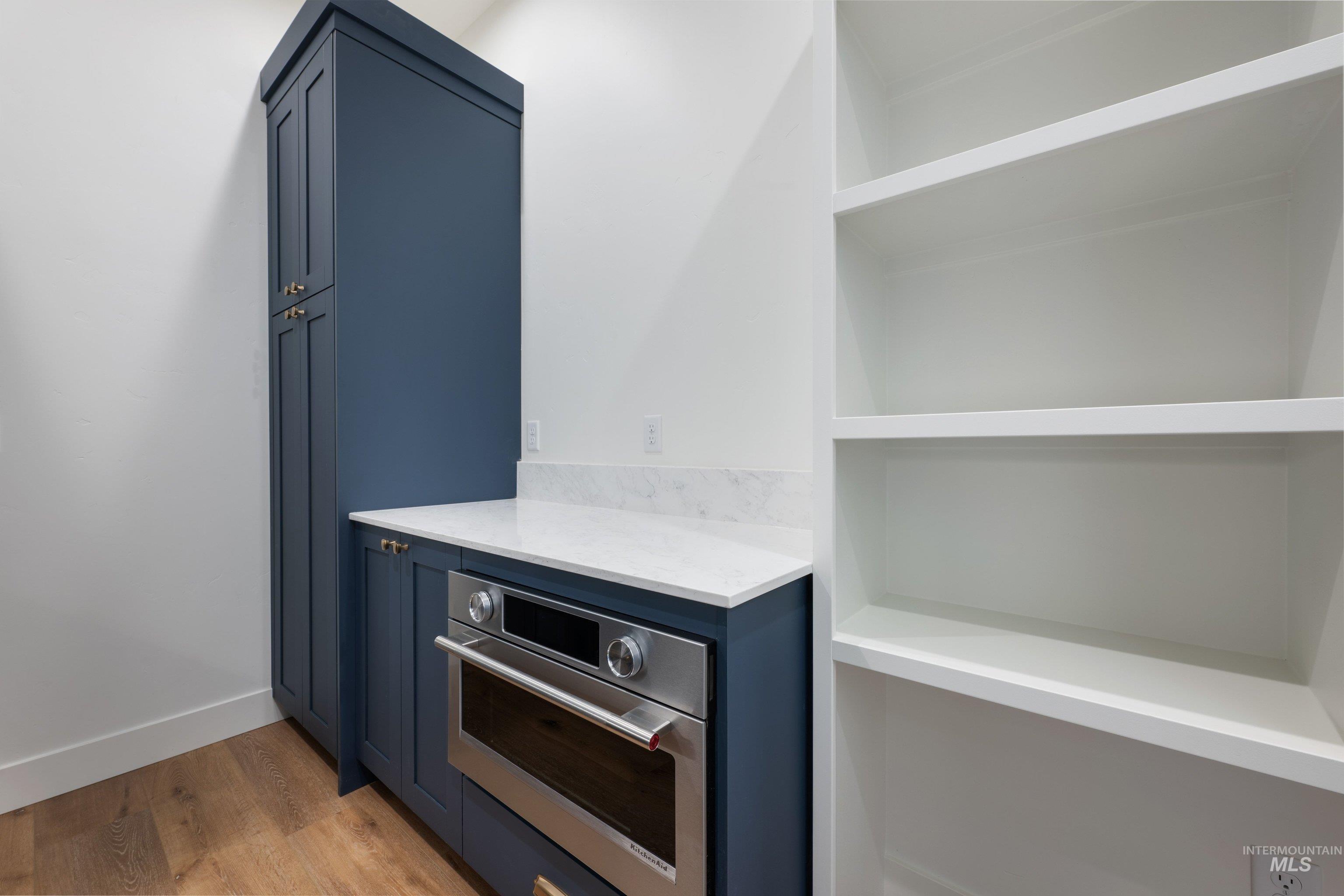 24821 Ardmore Court Caldwell, ID 83607 - Photo 24 of 43 Built-in oven with stainless steel finish, set within blue cabinetry