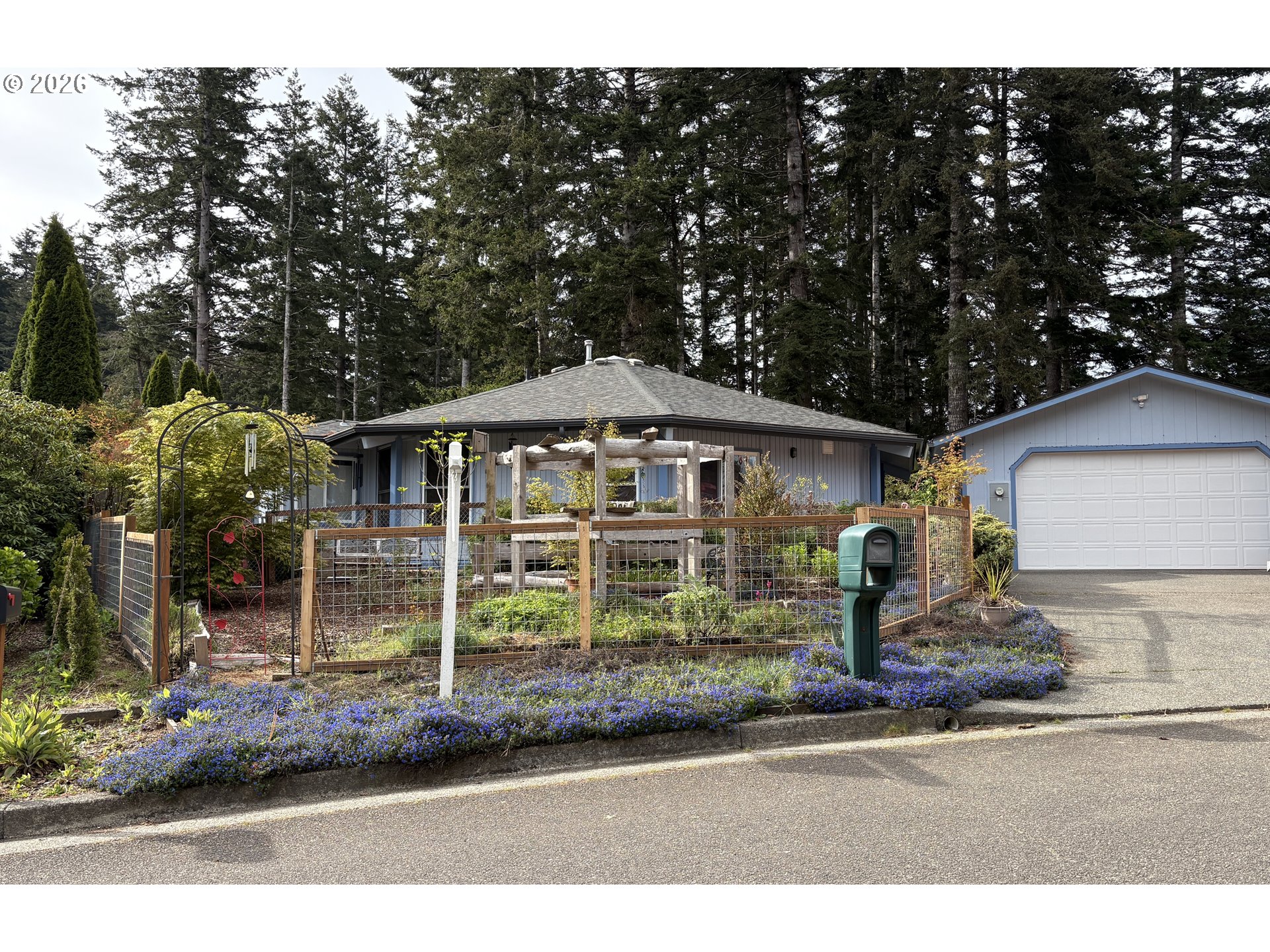 1625 Kristi Loop Lakeside, OR 97449 - Photo 3 of 41 a front view of a house with a garden