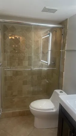 a bathroom with a toilet and a shower