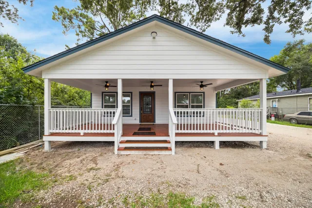 a view of a house with a deck and a yard