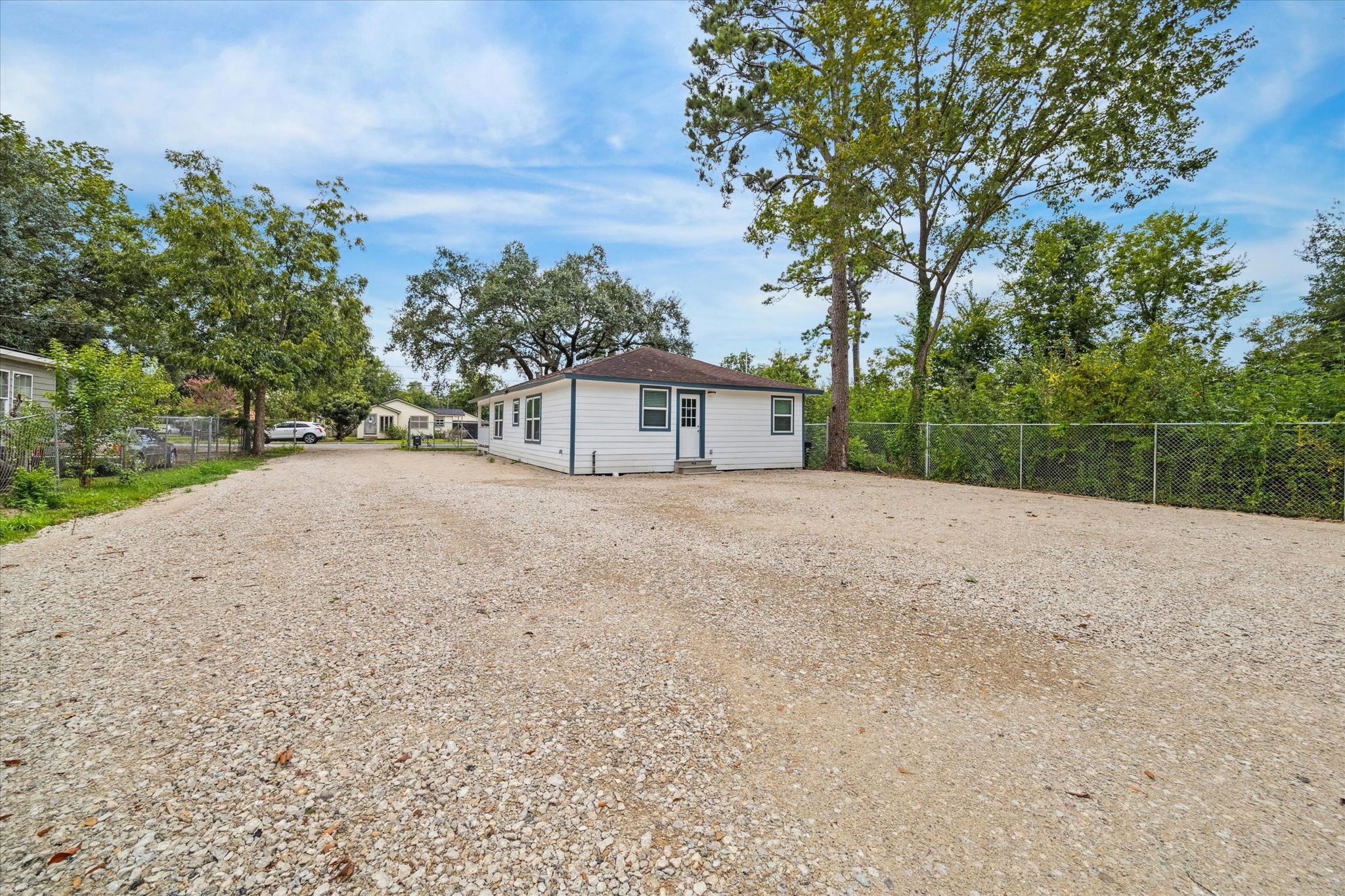 7229 Touchstone Street Houston, TX 77028 - Photo 11 of 11 a front view of a house with a garden and trees