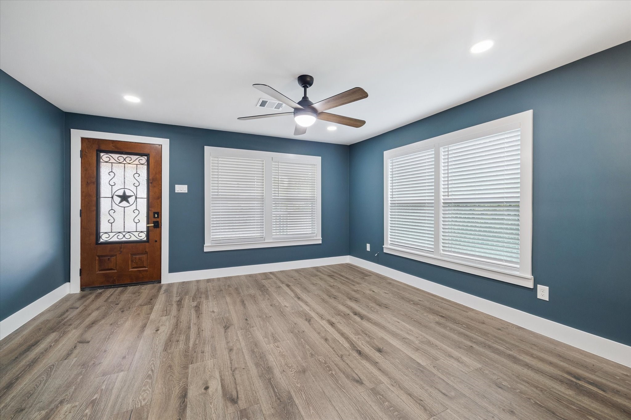 7229 Touchstone Street Houston, TX 77028 - Photo 4 of 11 a view of an empty room with a window and wooden floor