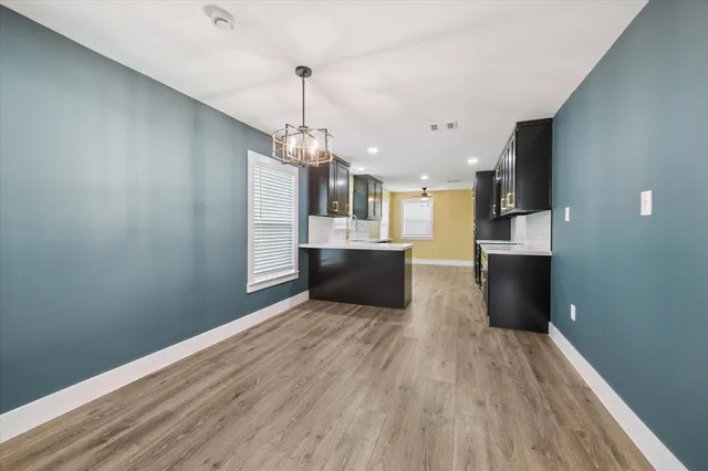 a view of a kitchen with a sink and wooden floor