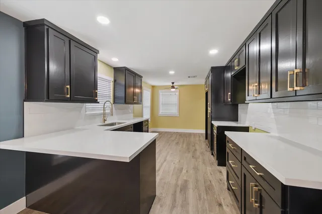 a kitchen with a sink appliances and cabinets