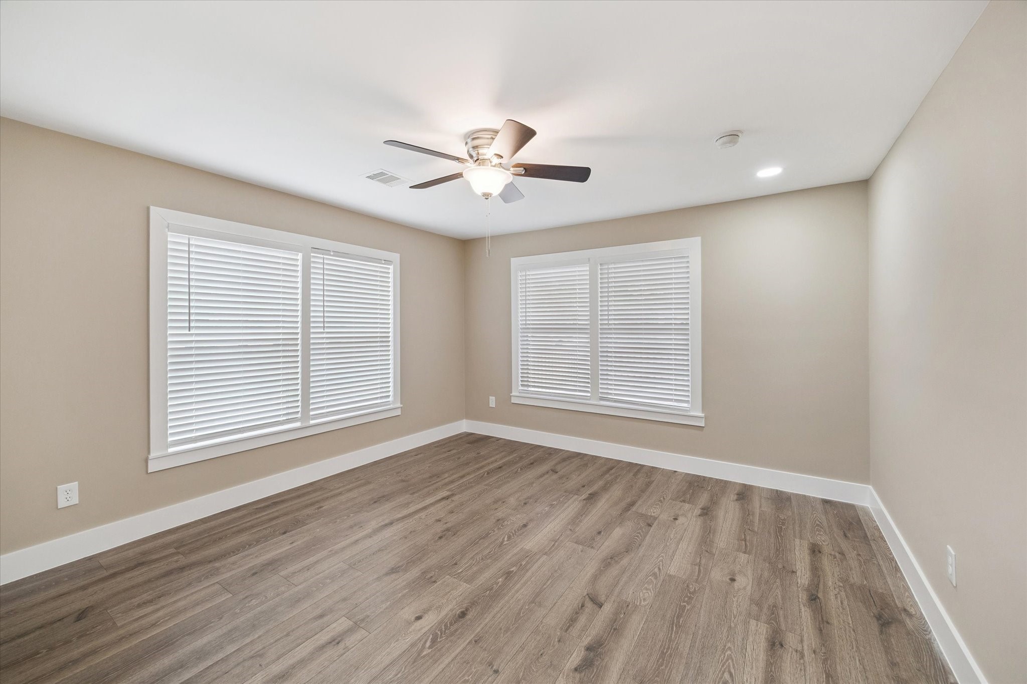 7229 Touchstone Street Houston, TX 77028 - Photo 7 of 11 a view of an empty room with a window and wooden floor