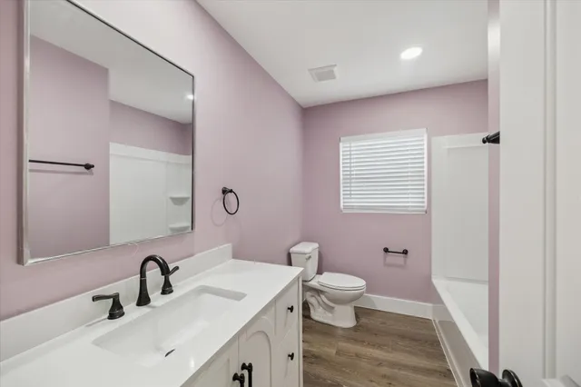 a bathroom with a sink a toilet and a mirror