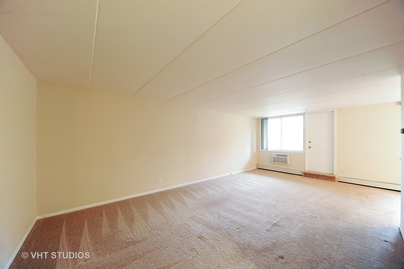 225 South Rohlwing Road, Unit 116 Palatine, IL 60074 - Photo 2 of 10 a view of an empty room and window