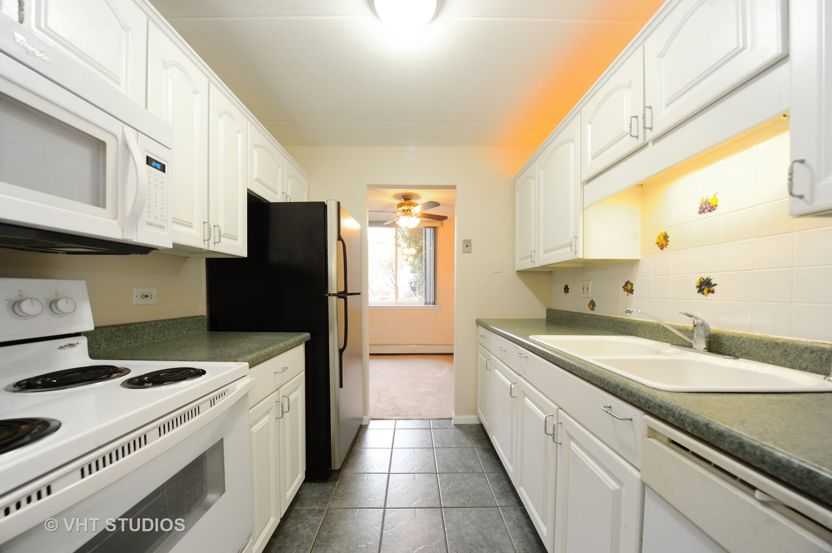 225 South Rohlwing Road, Unit 116 Palatine, IL 60074 - Photo 4 of 10 a kitchen with a sink stove and refrigerator