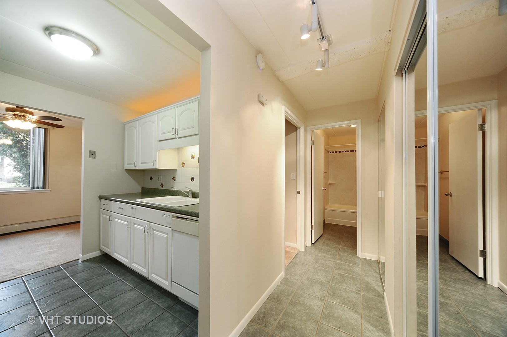 225 South Rohlwing Road, Unit 116 Palatine, IL 60074 - Photo 7 of 10 a kitchen with a stove a sink and a refrigerator