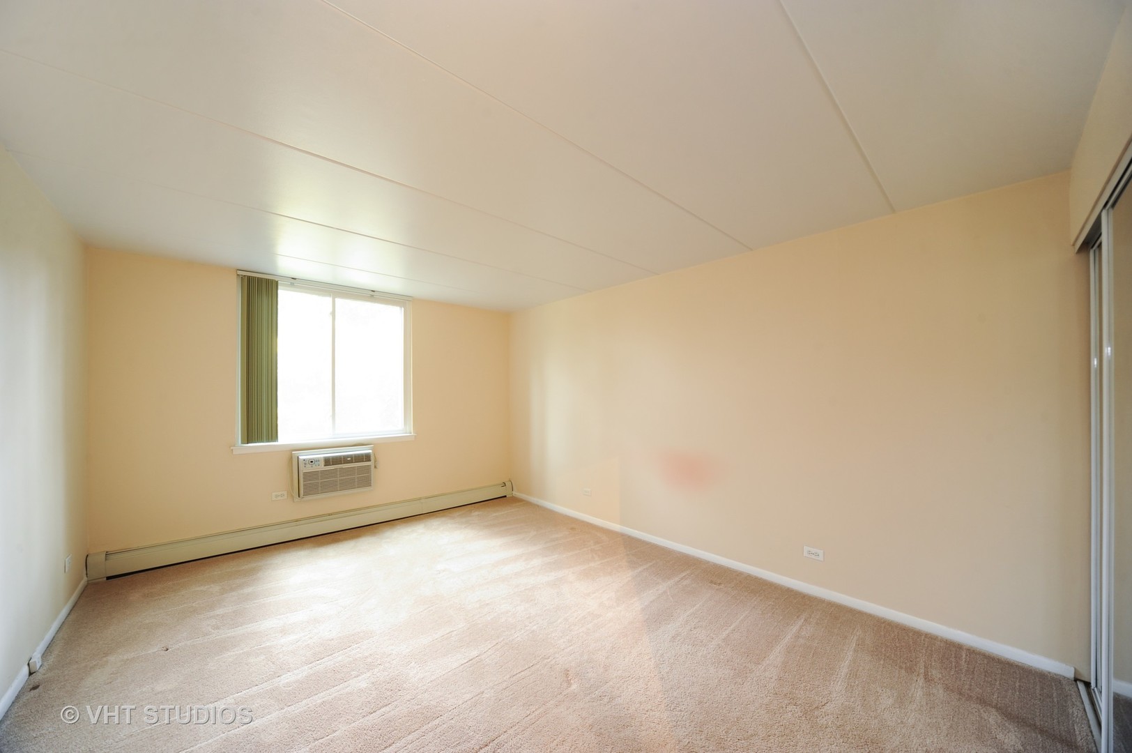 225 South Rohlwing Road, Unit 116 Palatine, IL 60074 - Photo 8 of 10 an empty room with a empty space and windows