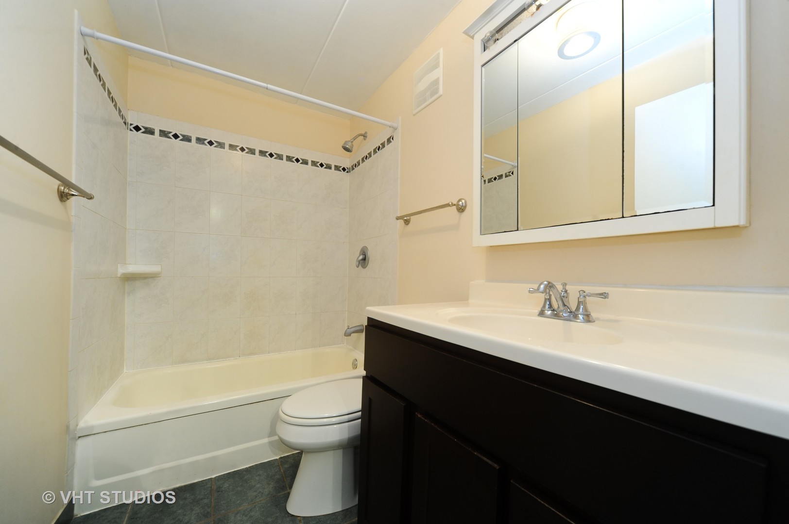 225 South Rohlwing Road, Unit 116 Palatine, IL 60074 - Photo 9 of 10 a bathroom with a granite countertop sink toilet a mirror and shower
