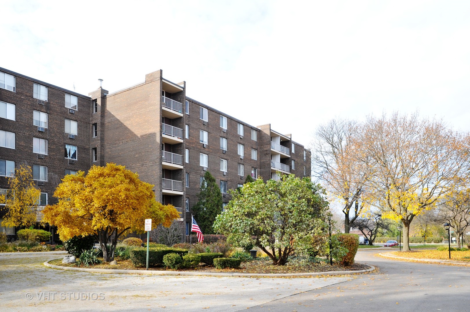 225 South Rohlwing Road, Unit 116 Palatine, IL 60074 - Photo 10 of 10 a view of a tall building next to a road