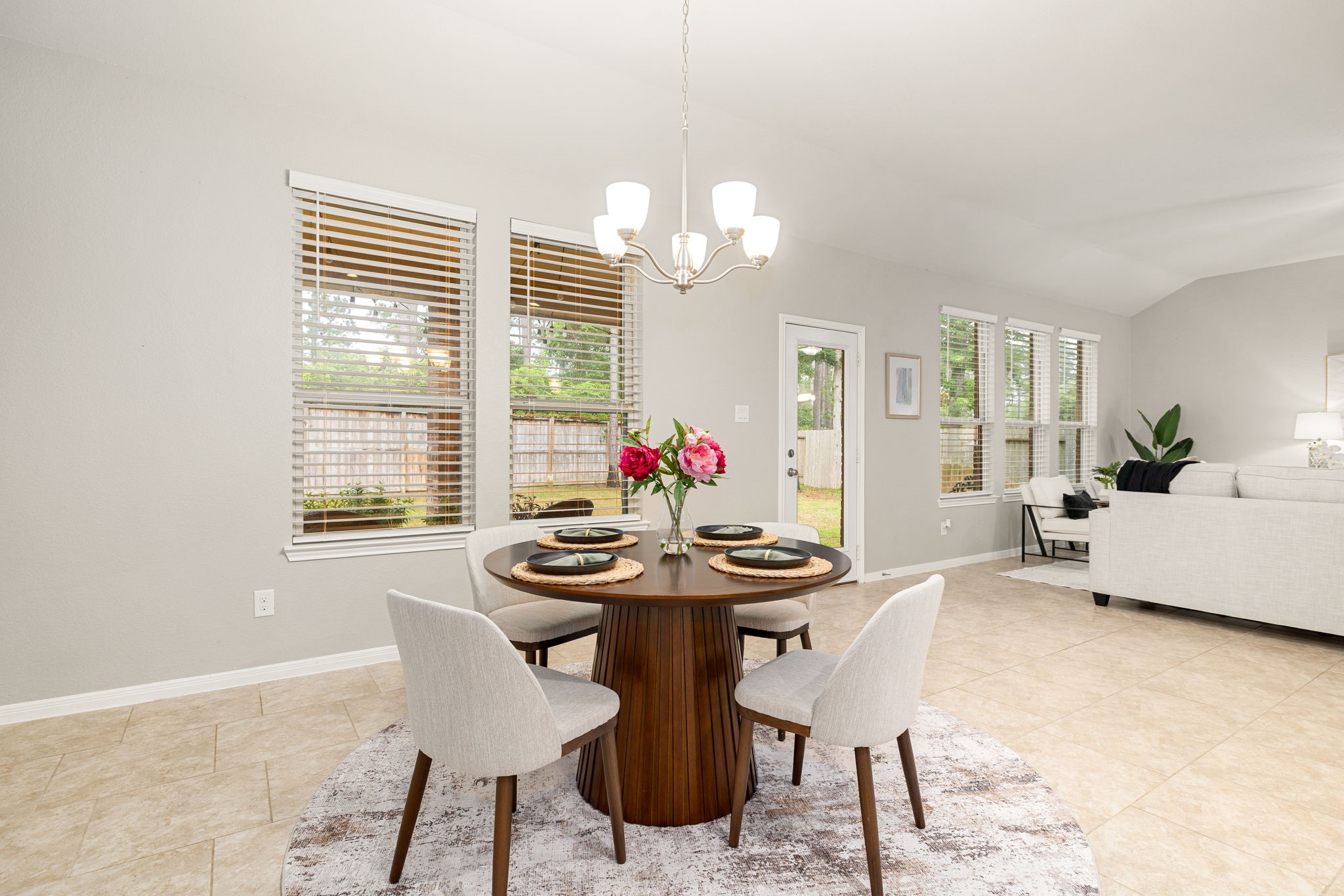 14023 Beaverhead Range Court Conroe, TX 77384 - Photo 12 of 30 A charming dining room serves as the perfect spot for family meals. Featuring gorgeous tile flooring, neutral-toned walls, large windows with fitted blinds, and chandelier lighting.