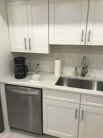 a kitchen with a sink and cabinets